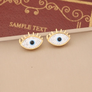 Golden evil eye stud earrings with white rhinestones and blue enamel on vintage book