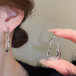 Detail of silver irregular flame gourd J-shaped earrings with liquid metal art finish