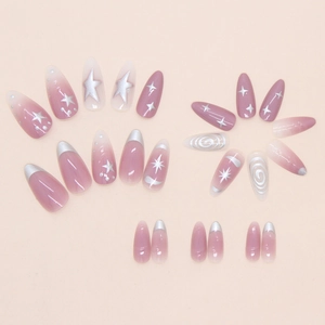 Macro view of gradient pink press-on nails with silver stars and French line details
