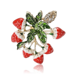 Fashionable enamel strawberry brooch with sparkling rhinestones on a gold metal base