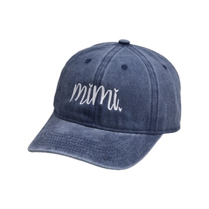 Close-up of white mimi embroidery on washed navy blue cotton baseball cap texture