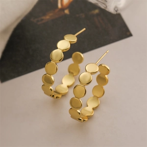 Detail view of 18K gold plated hoop earrings with textured small circular disk links
