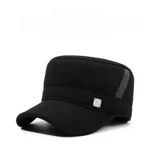 Detailed view of winter baseball cap with ear flaps and metal fashion logo accent
