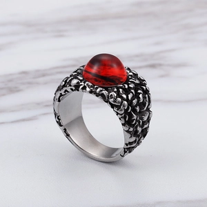 Close-up of vintage titanium steel ring with ruby gemstone and embossed textures