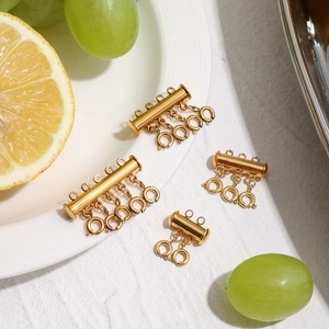 Detailed view of 18k gold layered necklace spacer clasps with fresh fruit decor