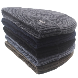 Stack of five colorful men's wool knitted beanies for winter warmth and outdoor cycling.