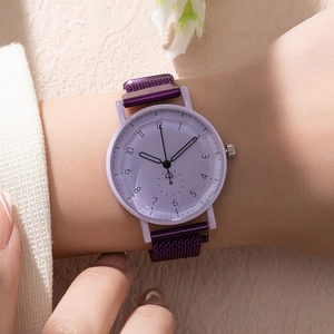 Elegant purple quartz watch with magnetic Milanese mesh strap on a stylish woman's wrist