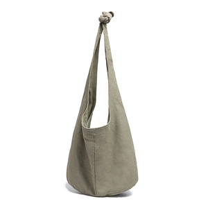 Detail of the knot shoulder strap on an olive green canvas hobo bag for daily use