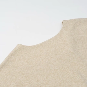 Close-up detail of knitted fabric texture and neckline on oatmeal vacation skirt set