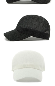 Detail of breathable knitted mesh baseball caps in black and white for summer sun protection