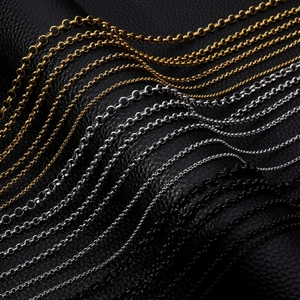 Detailed view of titanium steel round link chains in gold, silver, and black finishes