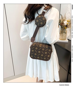 Detail of vintage brown floral crossbody camera bag with matching round coin purse on strap