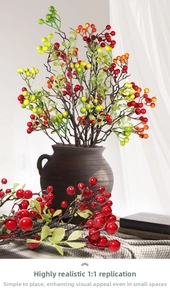 Detail of red and green artificial berries in a ceramic vase for home decoration