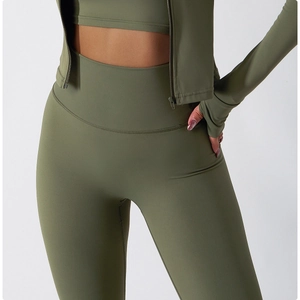 Detail of army green high-waisted leggings with thumb-hole zipper jacket and sports bra