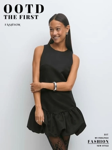 Detail view of the layered ruffle hem on this sleeveless black cocktail mini dress