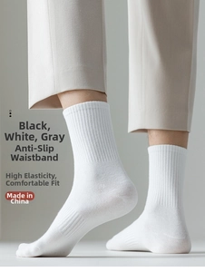 Detailed close-up of white ribbed crew socks made of breathable combed cotton