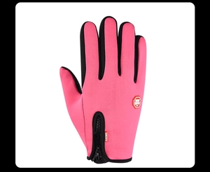 Detail of pink cycling gloves featuring adjustable zipper closure and windproof fabric
