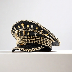 Detail of black sequins navy hat with gold metal studs and teardrop gems for parties