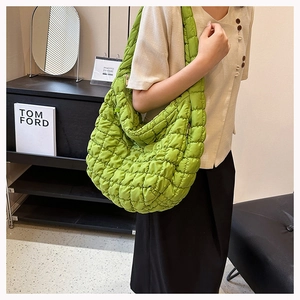 Detail of the grass green quilted puff texture and soft fabric on the shoulder cloud bag