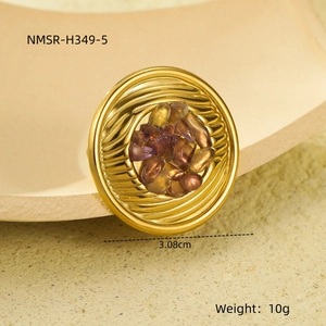 Detailed close-up of a gold textured ring with dark natural stone inlay and dimensions