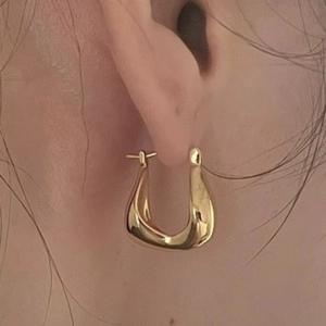 Minimalist gold U-shaped hoop earrings for women with a sleek irregular curved design