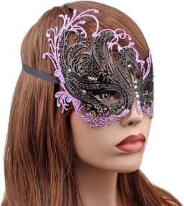Macro detail of purple and black Venetian laser-cut mask with glitter and rhinestones