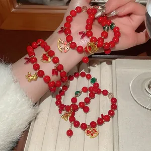 Red glass bead bracelet with golden horse and fortune bag charms in New Chinese style