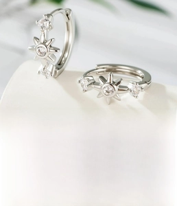 Detail of silver star hoop earring with 10mm inner diameter and sparkling cubic zirconia
