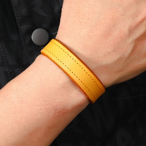 Close-up of yellow leather punk rock bracelet for men with double stitching details