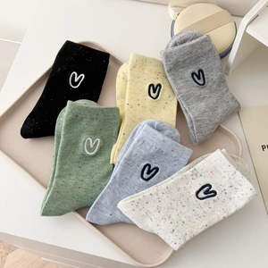 Detail of colorful speckled cotton socks with heart embroidery in multiple colors