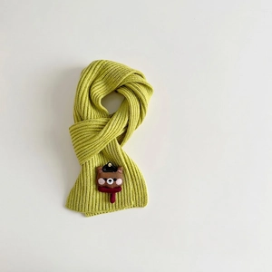 Close-up of ribbed green knit scarf featuring a cute 3D brown bear applique with hat