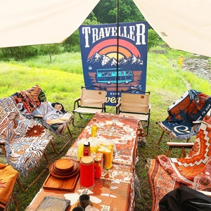 Detailed close-up of Bohemian woven camping blanket with fringe and ethnic patterns