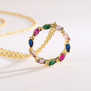 Gold plated circular pendant necklace with colorful marquise-cut zircons on white background