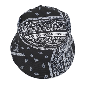 Top-down view of black bucket hat with white paisley bandana print and circular crown