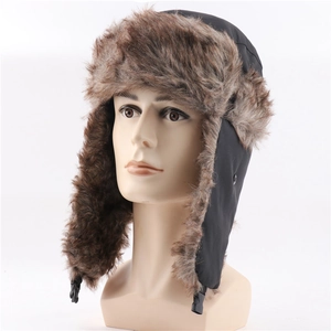 Detail of winter trapper hat featuring brown faux fur lining and black plastic chin buckle