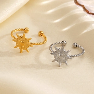 Fashionable 18K gold plated sun-shaped open rings in gold and silver on silk background
