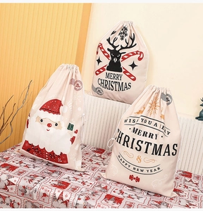 Detailed view of canvas Christmas drawstring bags with Santa and Reindeer prints