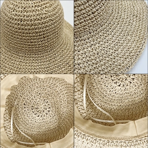 Foldable beige straw sun hat with wide brim and adjustable drawstring for beach sun protection