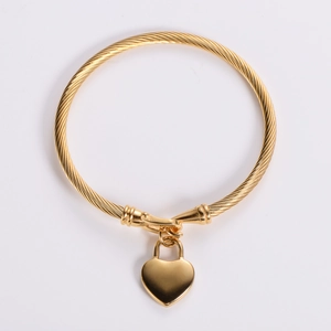 Polished 18k gold plated stainless steel cable wire bangle with a heart lock pendant