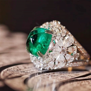 Vintage ring with a large emerald zircon center and pear-cut cluster of diamonds