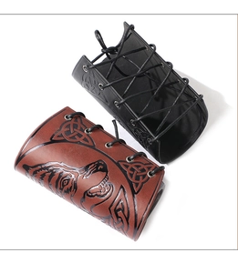 Detail of Viking PU leather wrist guards with embossed wolf head and Celtic knot patterns
