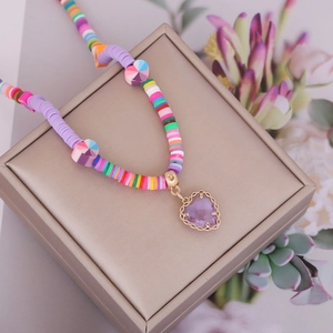 Bohemian colorful heishi bead necklace with purple heart pendant on jewelry box