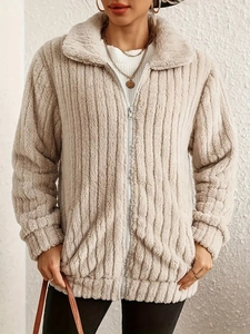 Elegant beige faux fur jacket with vertical stripes and silver zipper on model
