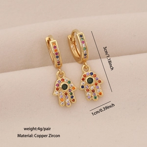 Detailed macro view of golden Hamsa Hand earrings with colorful inlaid zircon stones