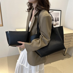 Large black leather tote and pouch set, minimalist shoulder bag for women on model