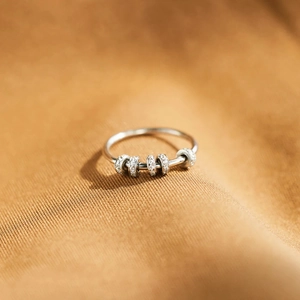 Macro view of rotating anxiety ring beads with cubic zirconia on S925 silver band