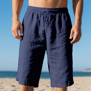 Detail of dark blue linen beach shorts with drawstring elastic waist and fabric texture