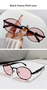 Detailansicht der ovalen Retro-Sonnenbrille mit schwarzem Metallrahmen und rosa Gläsern