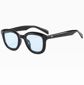 Detail of vintage square black sunglasses with light blue lenses and silver metal accents