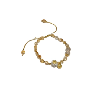 Adjustable yellow citrine and white crystal beaded bracelet with golden lotus charm